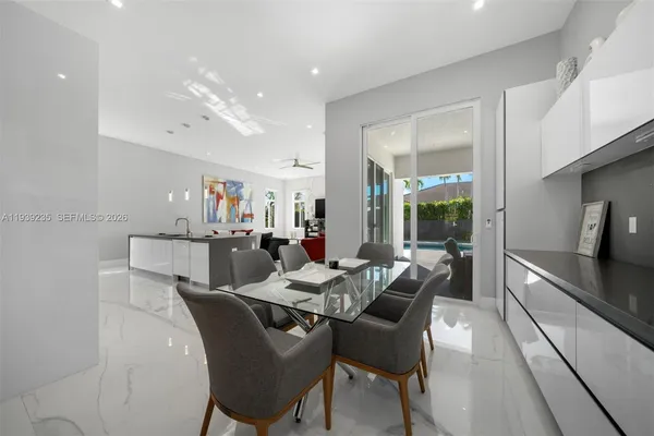 a large white kitchen with a large window