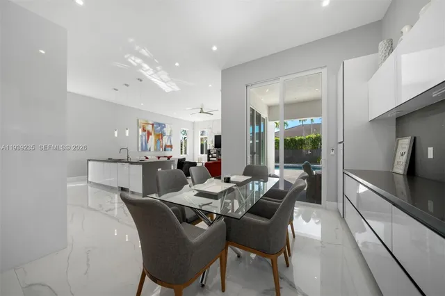 a large white kitchen with a large window