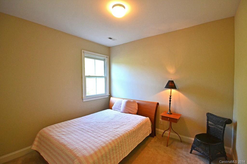 731 Julia Street Fort Mill, SC 29708 - Photo 16 of 20 a bedroom with a bed and a chair