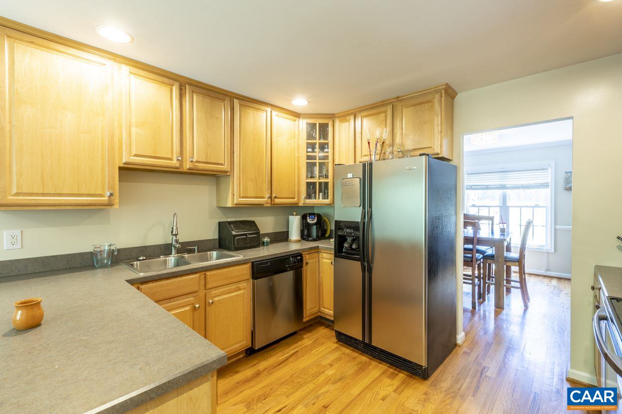161 Jordan Store Road Kents Store, VA 23084 - Photo 2 of 50 a kitchen with stainless steel appliances granite countertop a refrigerator a stove a sink a dining table and chairs with wooden floor