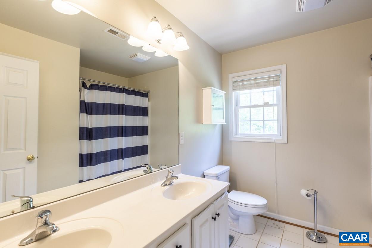 161 Jordan Store Road Kents Store, VA 23084 - Photo 27 of 50 a bathroom with a sink a toilet a shower and a mirror