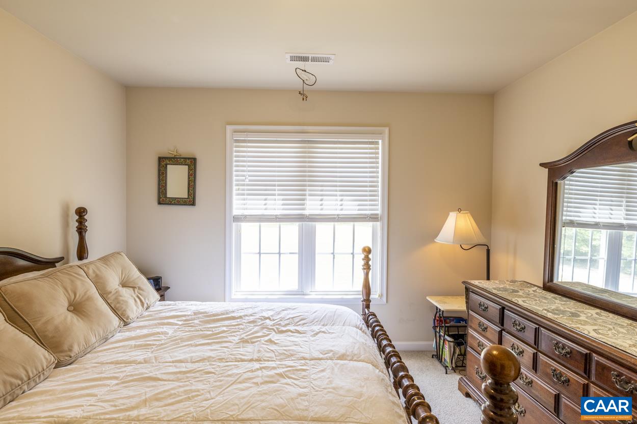 161 Jordan Store Road Kents Store, VA 23084 - Photo 31 of 50 a bedroom with a bed and a chandelier