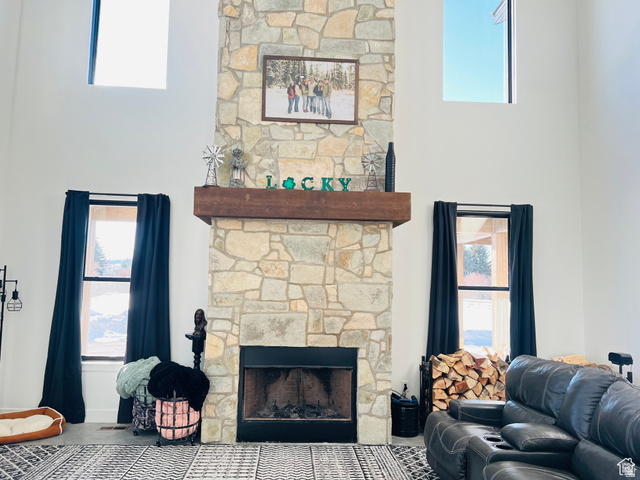 100 Whit Lane Georgetown, ID 83239 - Photo 19 of 76 Living room featuring a stone fireplace and a high ceiling
