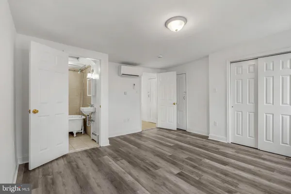 a view of a bedroom with wooden floor