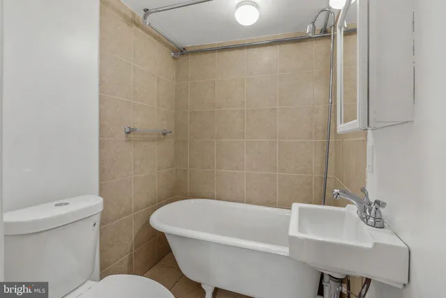 a white bath tub sitting next to a white toilet