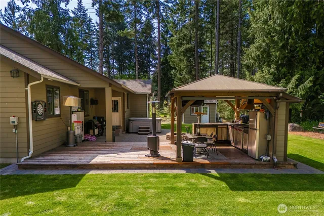 a view of a chair and table in the patio next to a yard