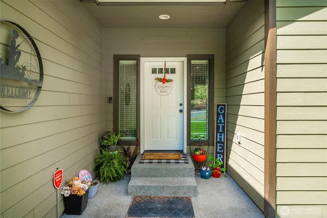 a living room with furniture a wooden floor and kitchen view