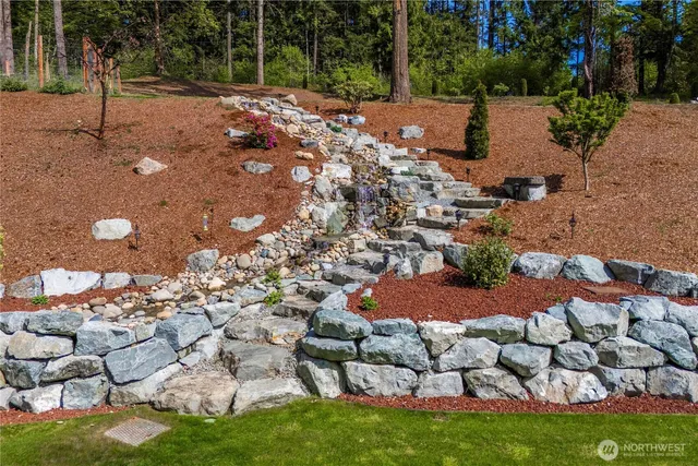 a view of a table and chairs in backyard
