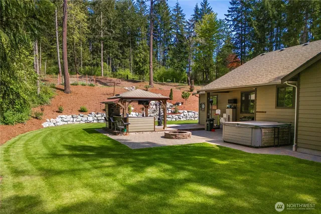 a view of backyard with swimming pool and outdoor seating