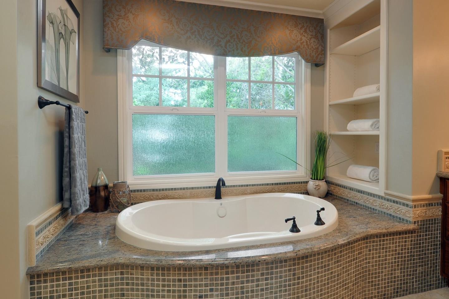 738 Springer Road Los Altos, CA 94024 - Photo 12 of 25 a bath tub sitting in a bathroom next to a window