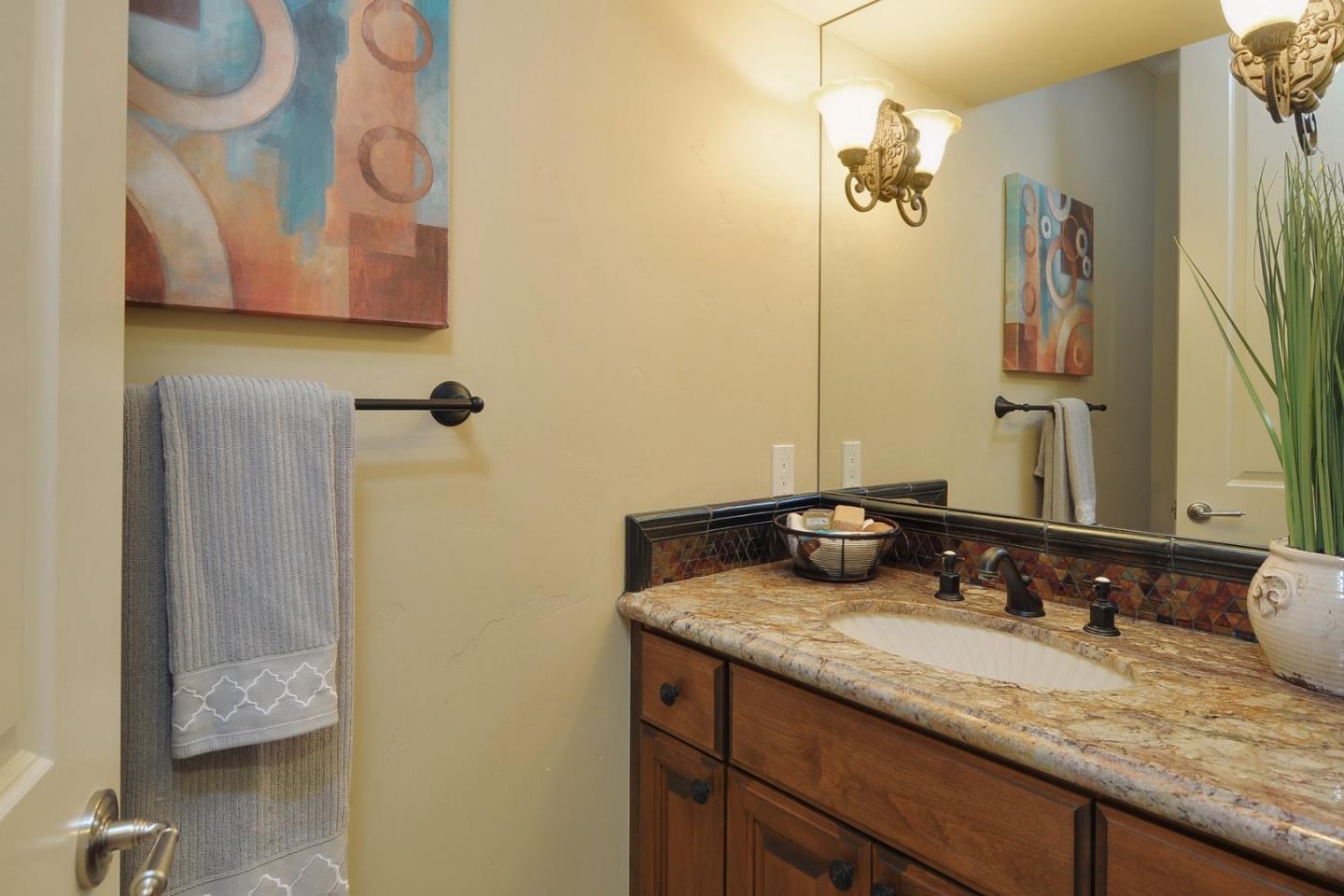 738 Springer Road Los Altos, CA 94024 - Photo 19 of 25 a bathroom with a granite countertop sink and a mirror