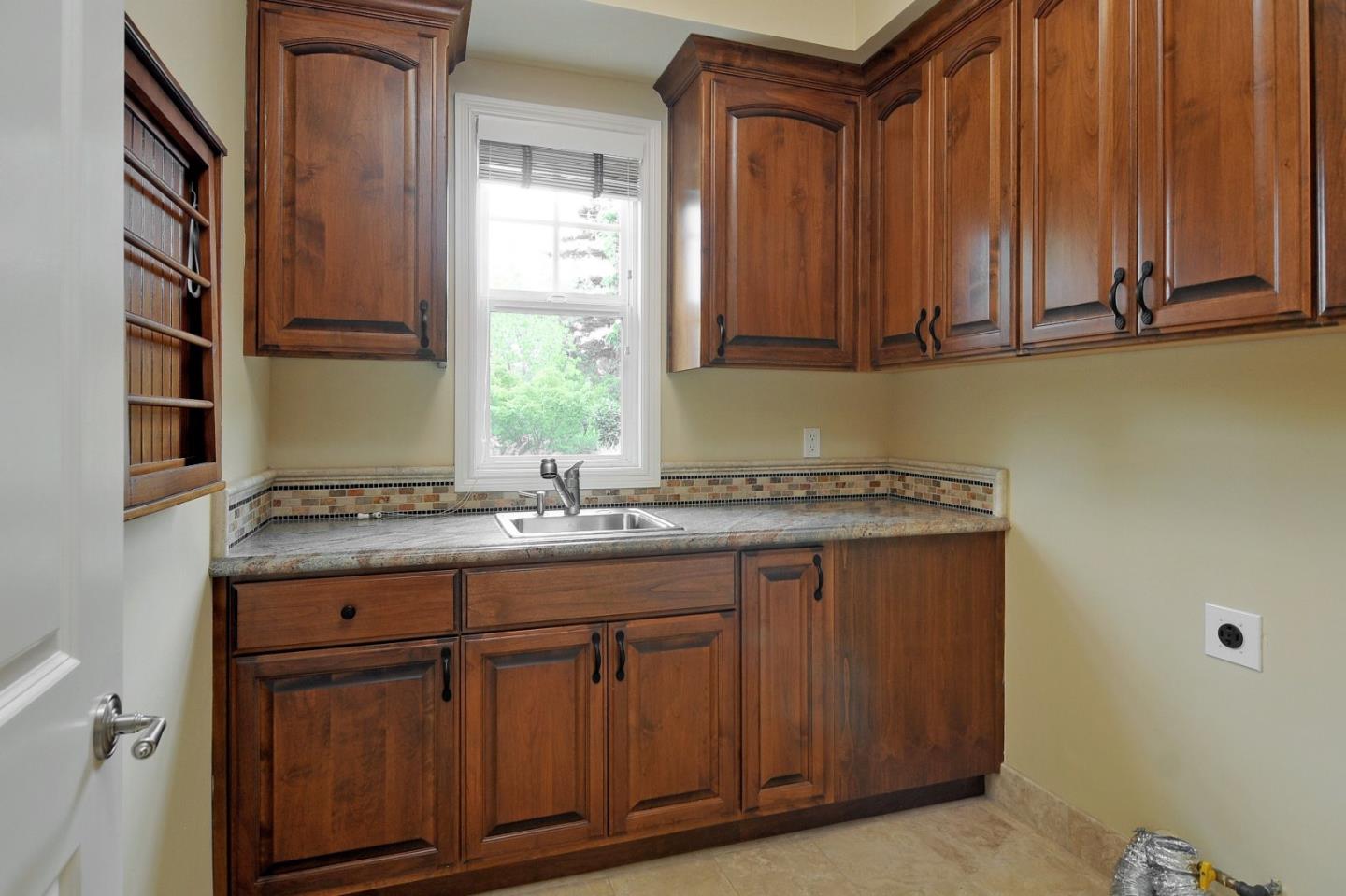 738 Springer Road Los Altos, CA 94024 - Photo 22 of 25 a kitchen with a sink cabinets and a window