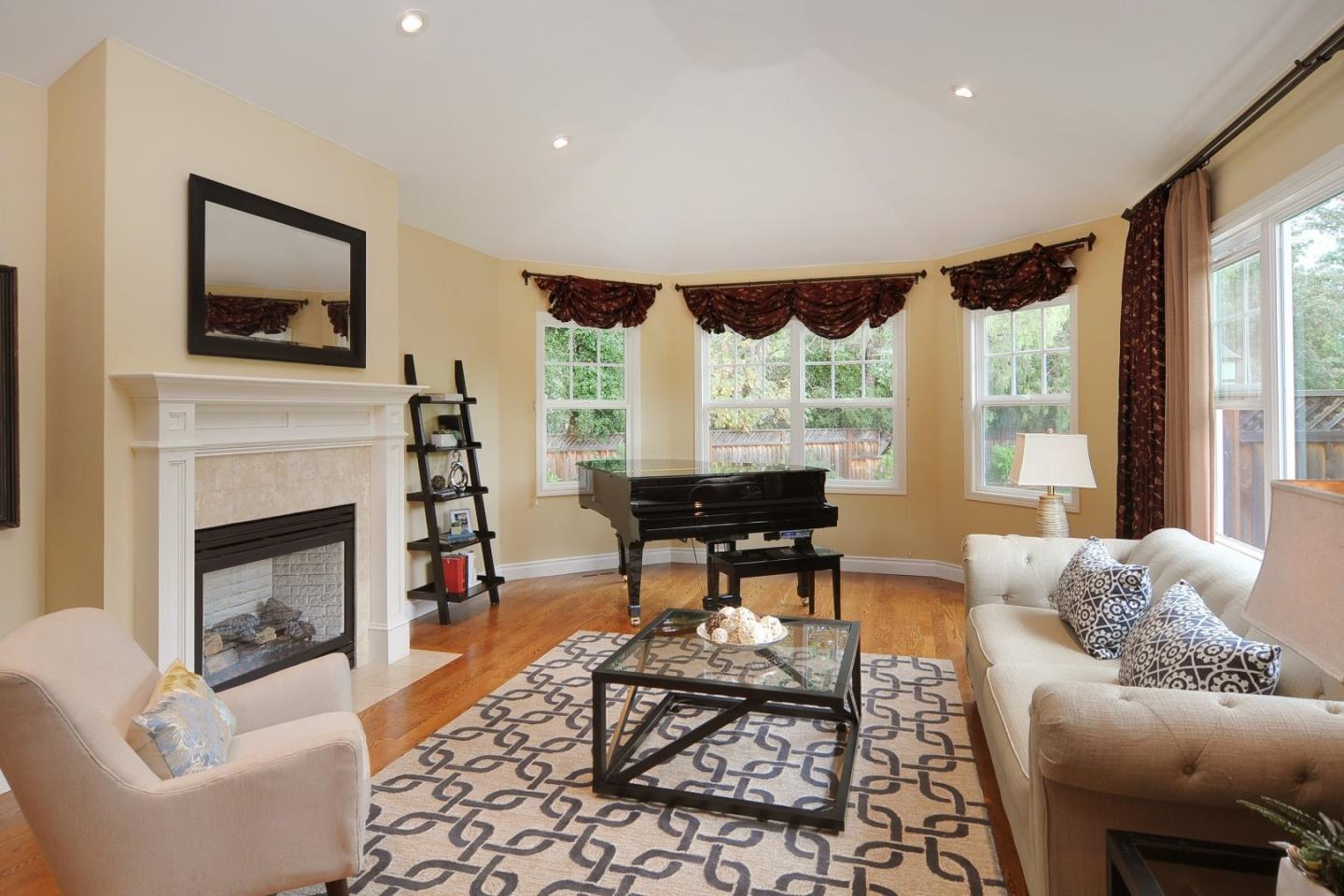 738 Springer Road Los Altos, CA 94024 - Photo 3 of 25 a living room with furniture a window and a fireplace