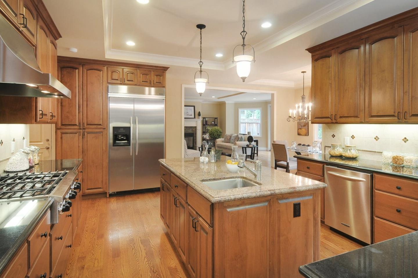 738 Springer Road Los Altos, CA 94024 - Photo 6 of 25 a kitchen with stainless steel appliances granite countertop a sink stove and refrigerator