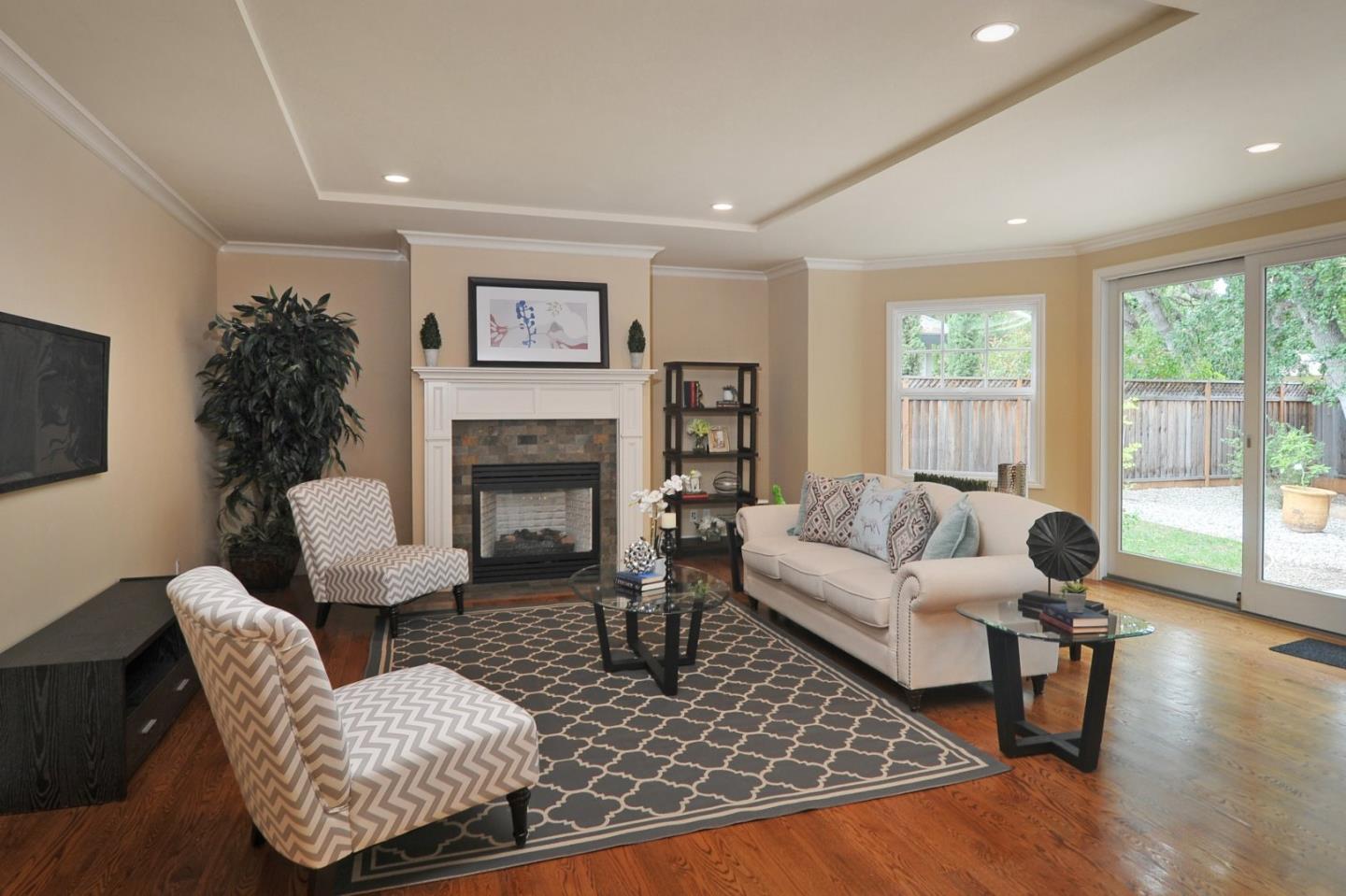 738 Springer Road Los Altos, CA 94024 - Photo 8 of 25 a living room with furniture a large window and a fireplace