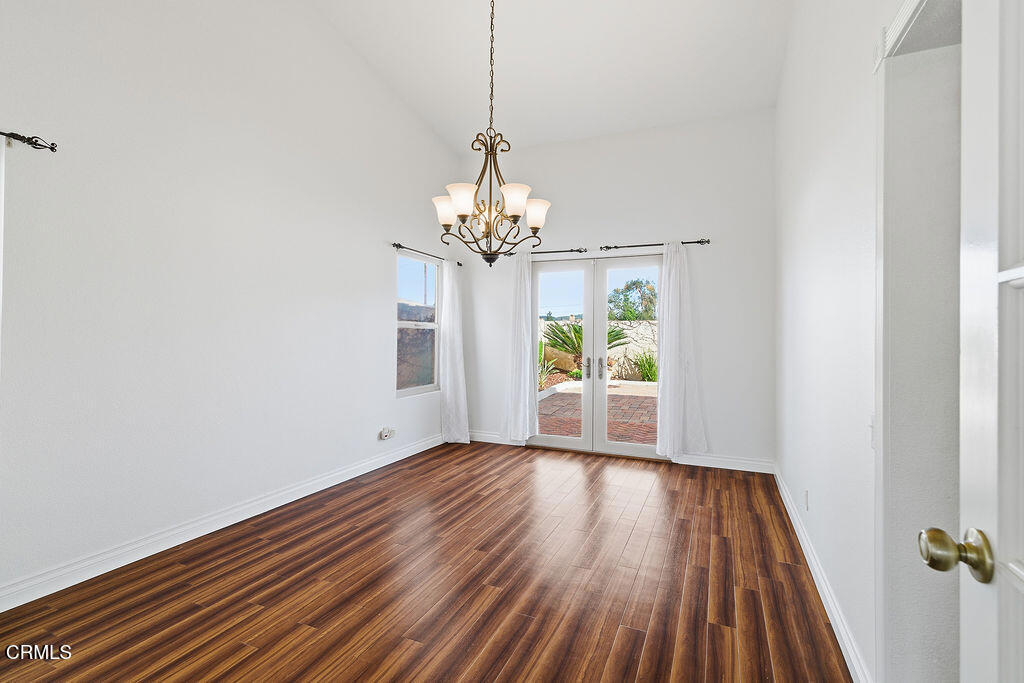 4024 Cliffrose Avenue Moorpark, CA 93021 - Photo 11 of 40 a view of a room with wooden floor chandelier and a window