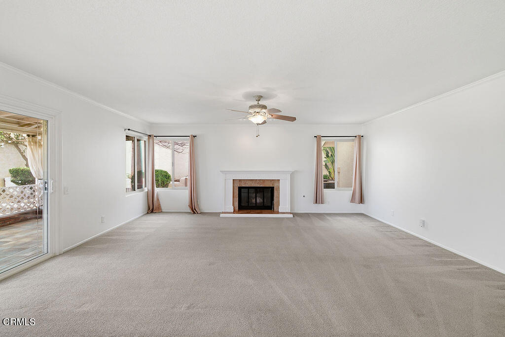 4024 Cliffrose Avenue Moorpark, CA 93021 - Photo 17 of 40 a view of an empty room with a fireplace and a window