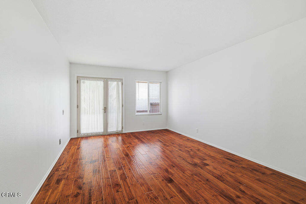 4024 Cliffrose Avenue Moorpark, CA 93021 - Photo 20 of 40 a view of an empty room with wooden floor and window