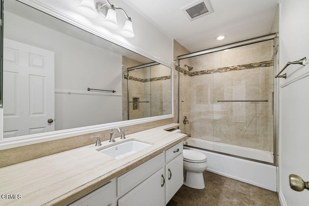 4024 Cliffrose Avenue Moorpark, CA 93021 - Photo 31 of 40 a bathroom with a granite countertop sink a toilet and shower