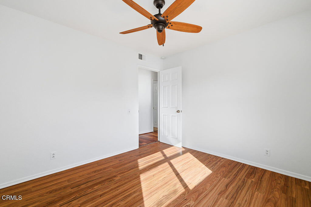 4024 Cliffrose Avenue Moorpark, CA 93021 - Photo 35 of 40 a view of a room with wooden floor and a ceiling fan
