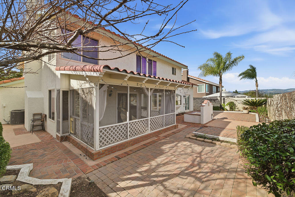 4024 Cliffrose Avenue Moorpark, CA 93021 - Photo 37 of 40 a view of a white house with a large tree and wooden fence