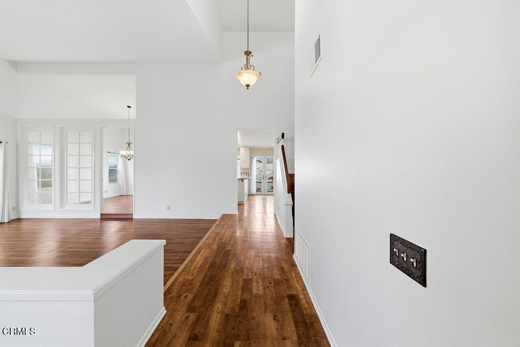 4024 Cliffrose Avenue Moorpark, CA 93021 - Photo 7 of 40 a view of a hallway with wooden floor and staircase