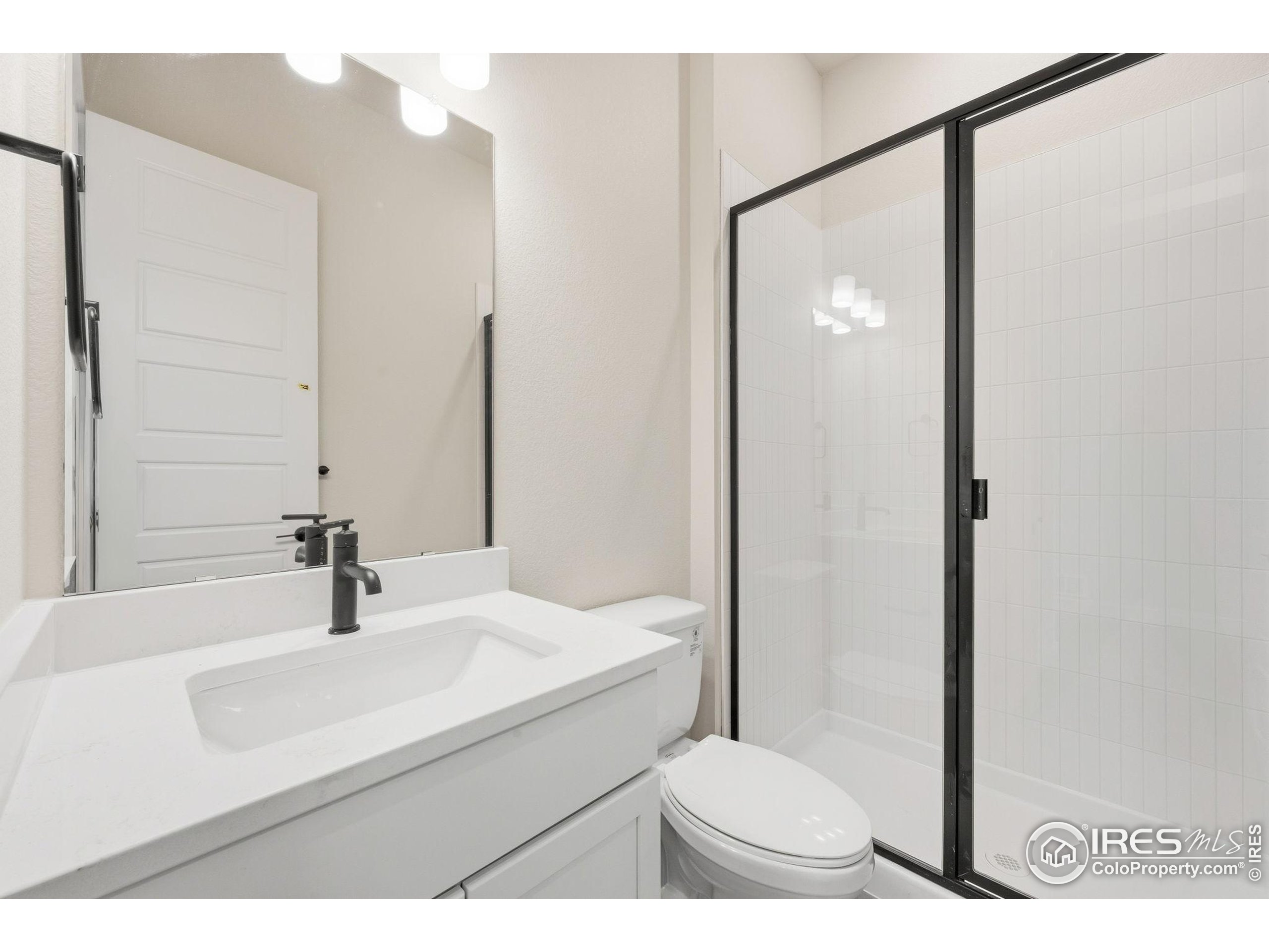 1675 Sundown Run Drive Windsor, CO 80550 - Photo 12 of 15 a bathroom with a sink and a mirror