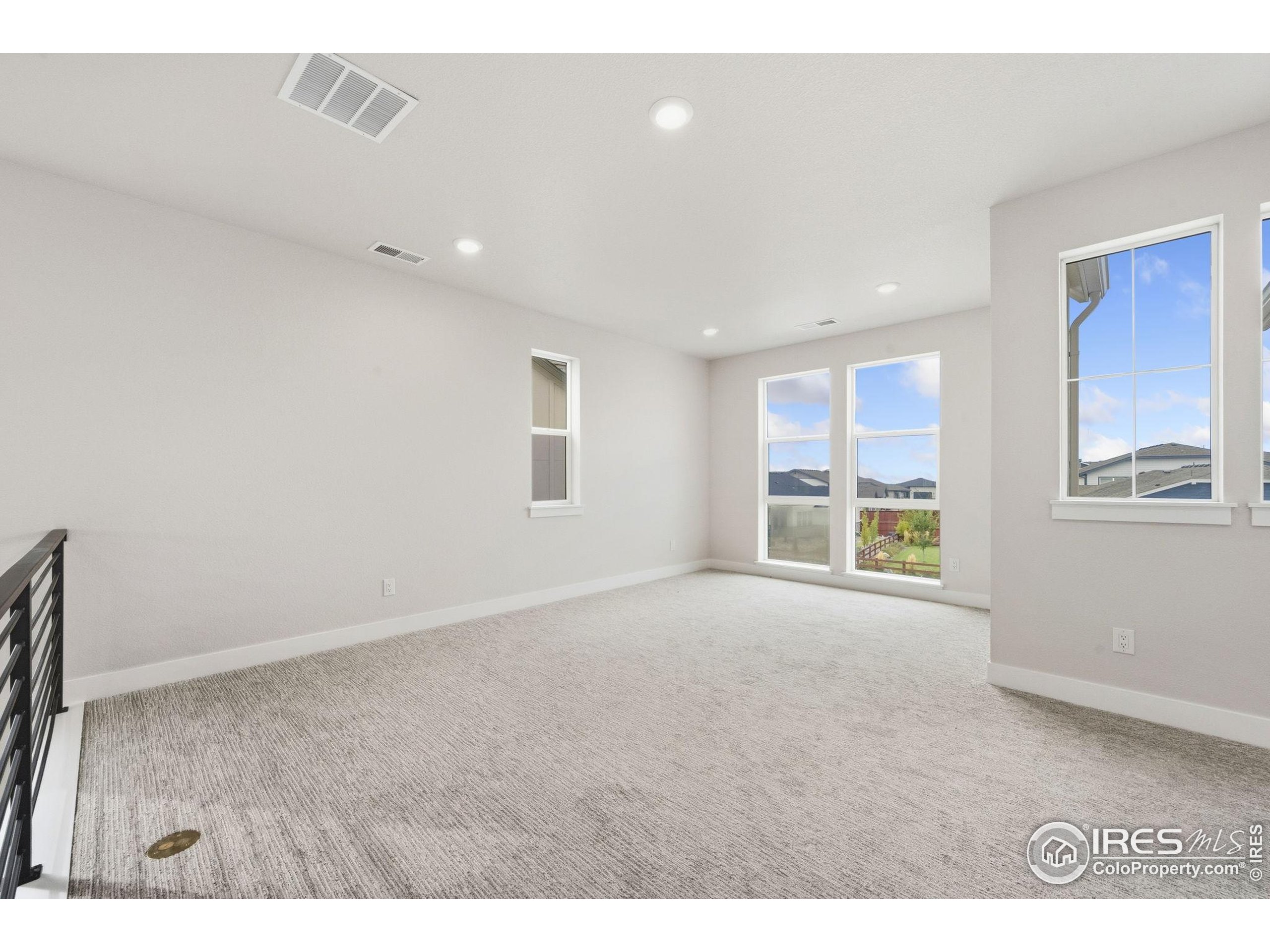 1675 Sundown Run Drive Windsor, CO 80550 - Photo 6 of 15 a view of an empty room with a window