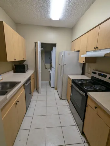 a kitchen with a stove a sink and a refrigerator