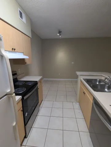 a kitchen with a stove and a sink