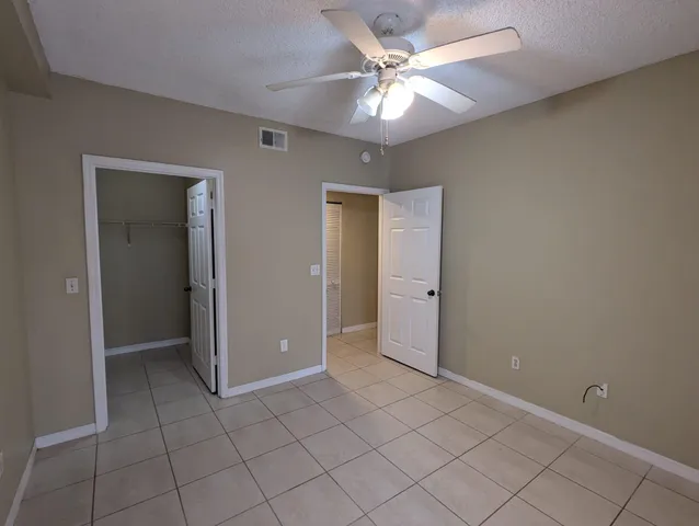an empty room with fan and fan