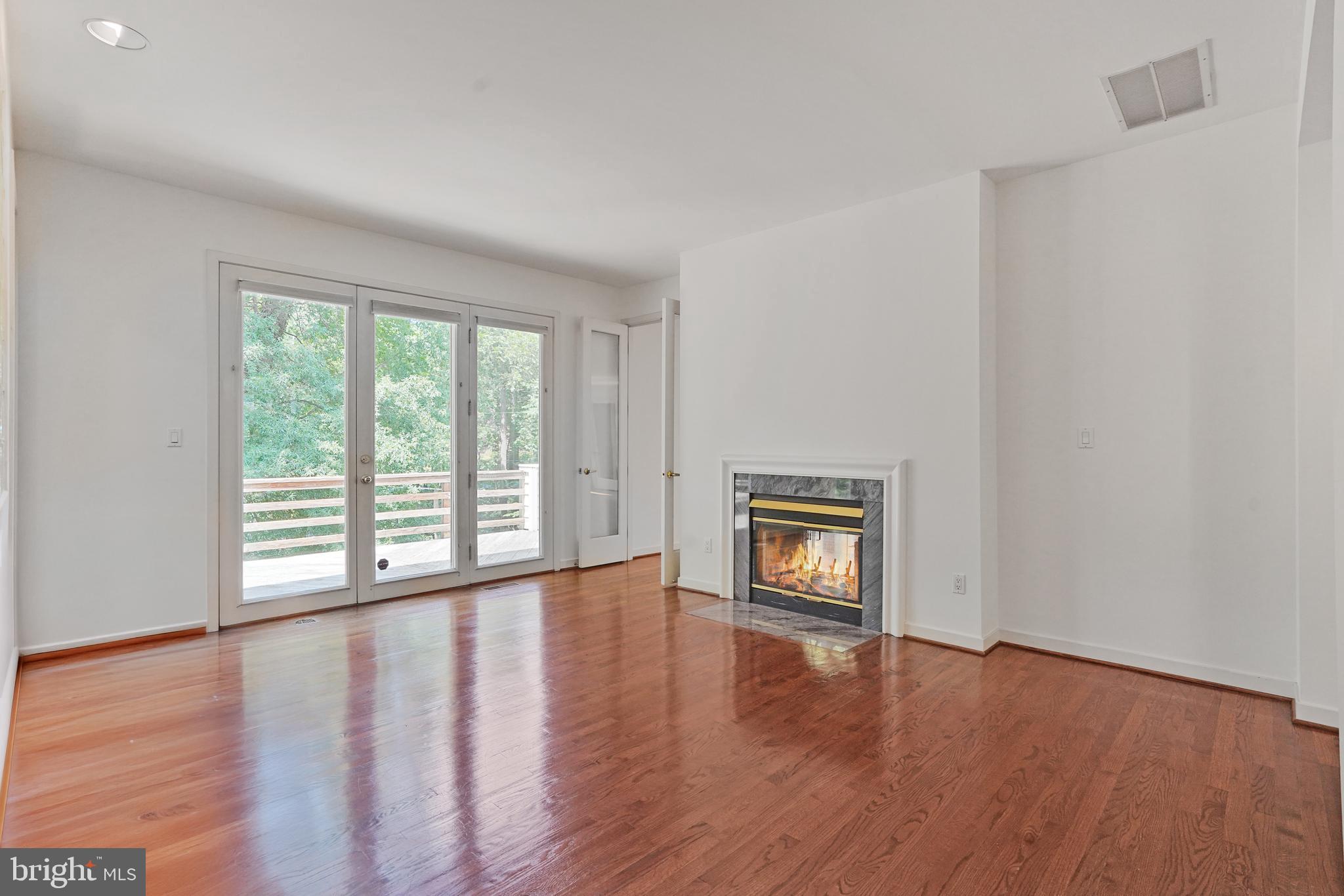 926 Saigon Road McLean, VA 22102 - Photo 14 of 54 Double-sided Wood Fireplace b/w Living & Dining
