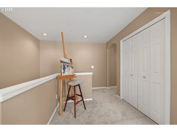 a view of a hallway with a table and chairs