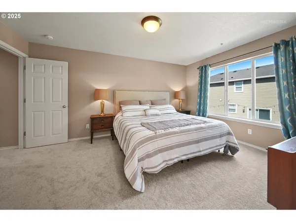 a bedroom with a bed and a large window