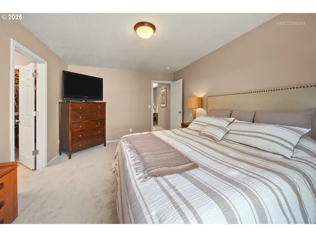 a bedroom with a bed and a television