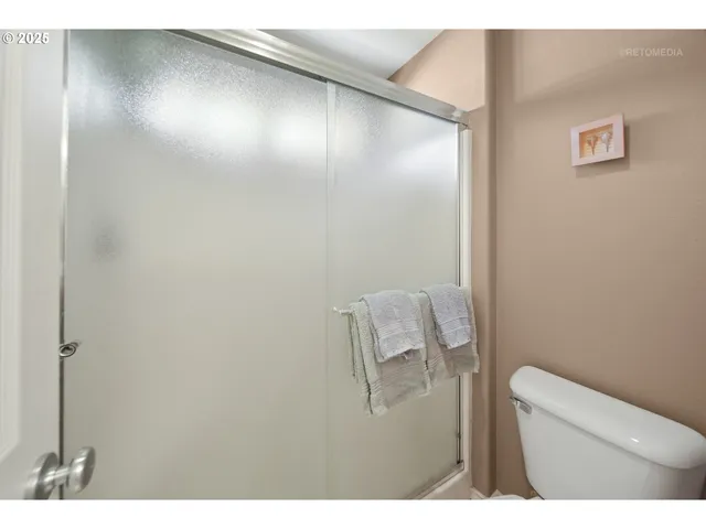 a bathroom with a toilet and a mirror
