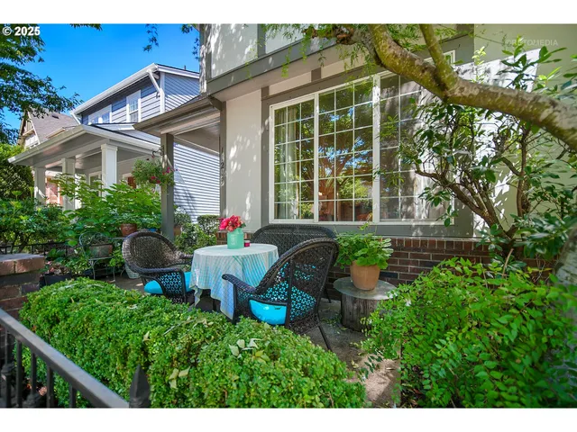 a view of a house with backyard sitting area and garden