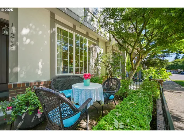 a view of a house with backyard sitting area and garden