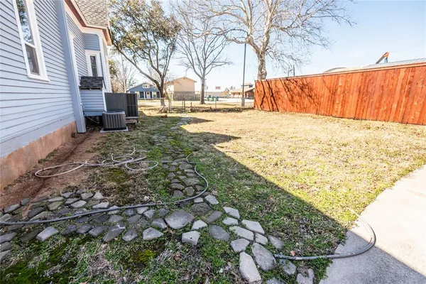 a view of back yard with wooden fence