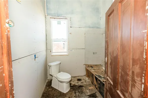 a bathroom with a toilet a sink and shower