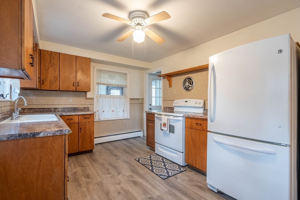 838 Pleasant Street Rochdale, MA 01542 - Photo 11 of 30 a kitchen with a refrigerator stove and sink
