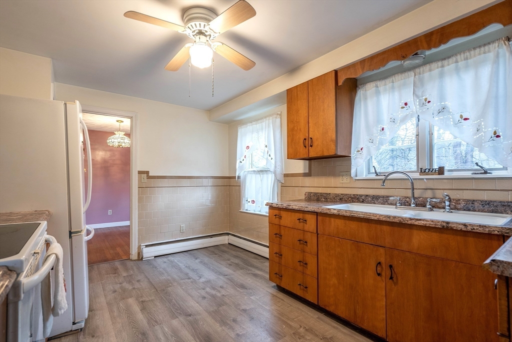 838 Pleasant Street Rochdale, MA 01542 - Photo 12 of 30 a kitchen with a sink cabinets and wooden floor