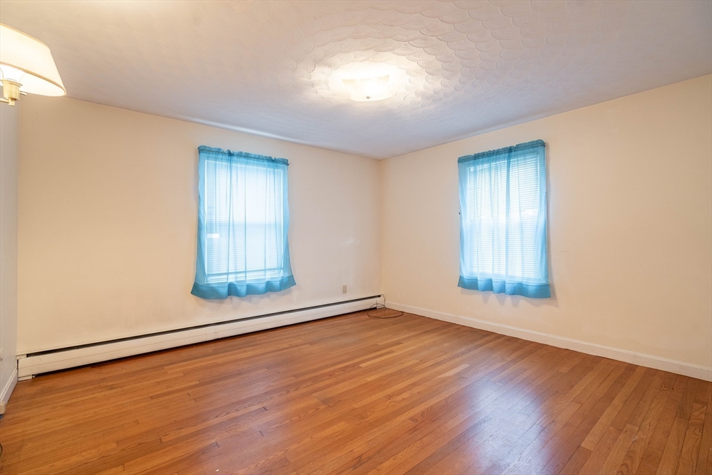 838 Pleasant Street Rochdale, MA 01542 - Photo 15 of 30 an empty room with wooden floor and windows