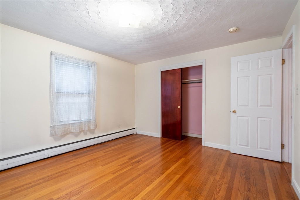 838 Pleasant Street Rochdale, MA 01542 - Photo 18 of 30 an empty room with wooden floor and closet
