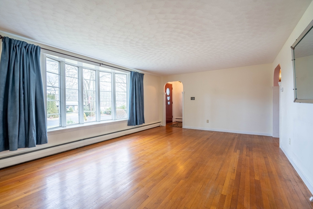 838 Pleasant Street Rochdale, MA 01542 - Photo 10 of 30 a view of an empty room with wooden floor and a window