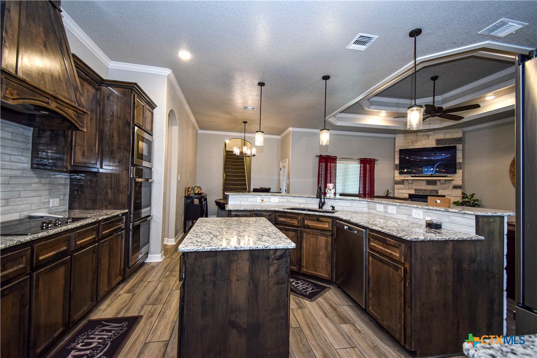 7623 Palladium Loop Killeen, TX 76542 - Photo 11 of 48 a kitchen with stainless steel appliances granite countertop a sink stove and refrigerator