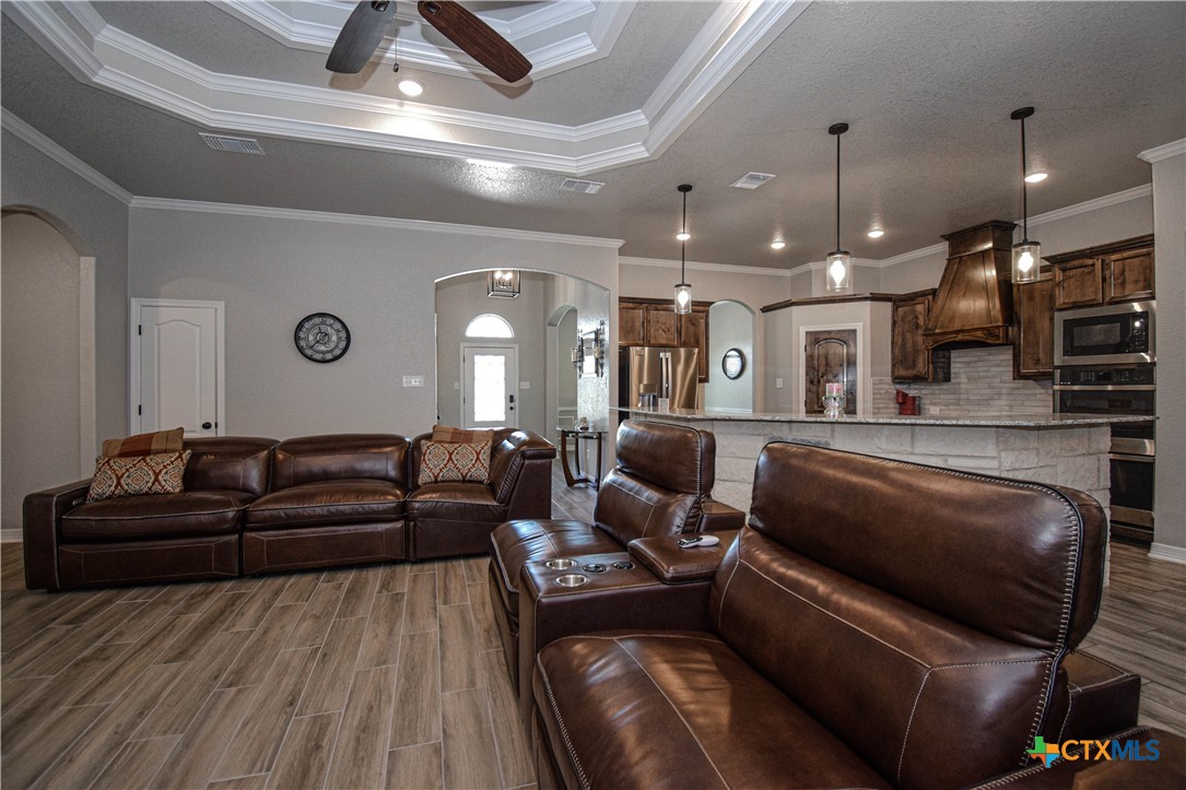 7623 Palladium Loop Killeen, TX 76542 - Photo 17 of 48 a living room with furniture ceiling fan and a wooden floor