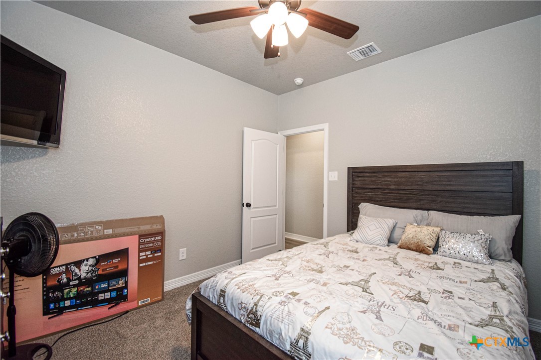 7623 Palladium Loop Killeen, TX 76542 - Photo 26 of 48 a bedroom with a bed and a fireplace