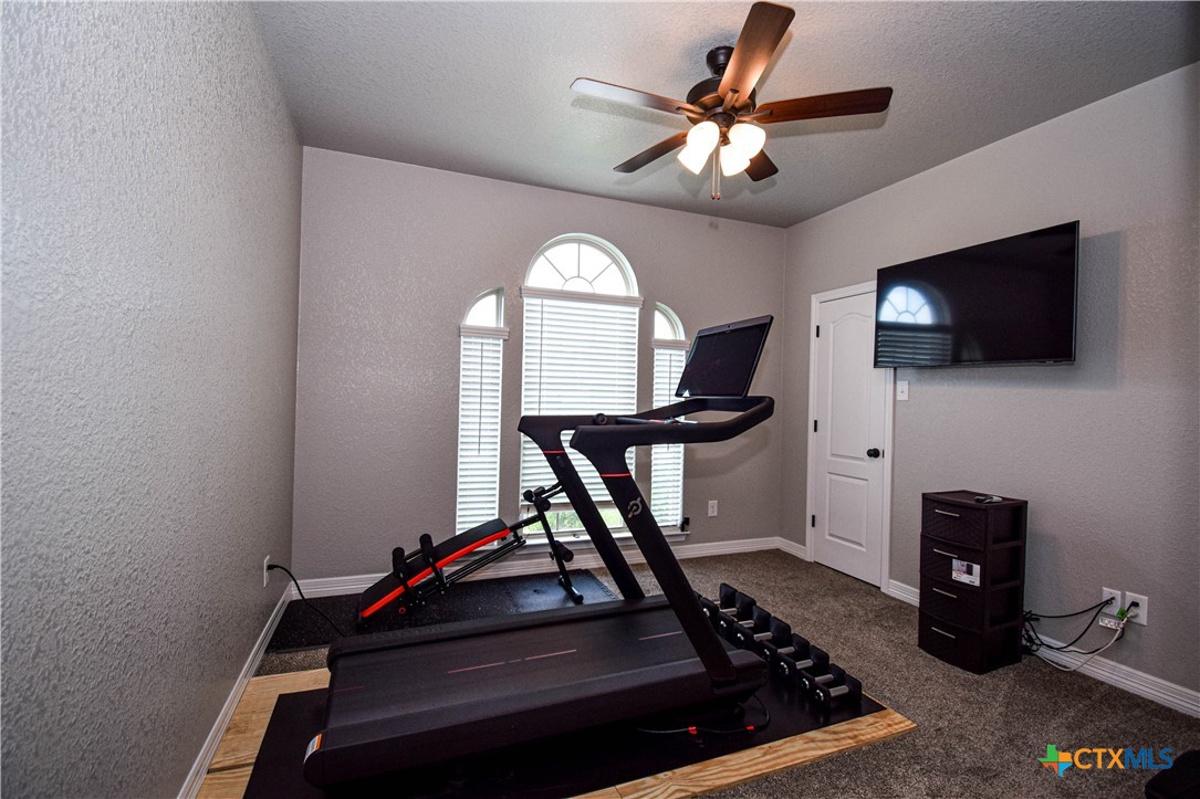 7623 Palladium Loop Killeen, TX 76542 - Photo 27 of 48 a room with gym equipment and a flat screen tv