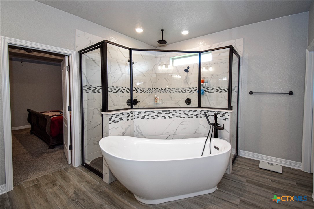 7623 Palladium Loop Killeen, TX 76542 - Photo 32 of 48 a bathroom with a bathtub and shower